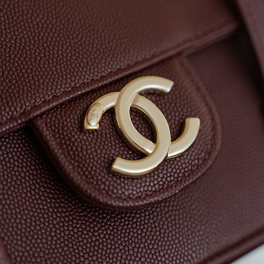 Close-up of Chanel double C logo on Bordeaux color of 26C Jennie’s New Chanel Bag AP5248 Preppy Coco Chanel vintage shoulder bag