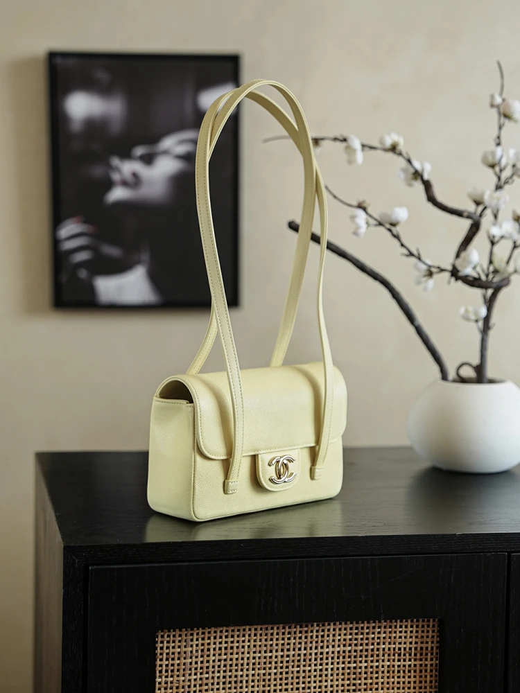 Left view of pale yellow 26C Jennie’s New Chanel Bag AP5248 Preppy Coco Chanel vintage shoulder bag with double C logo