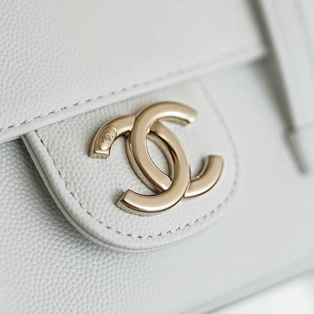 Close-up of Chanel double C logo on White color of Jennie’s New Chanel 26C AP5248 Preppy Coco Chanel vintage shoulder bag